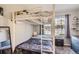 bedroom featuring a bunk bed, large window, and neutral decor at 2890 W Long Cir # A, Littleton, CO 80120