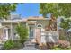 Charming front entrance with brick pillar and lush greenery for added curb appeal at 2890 W Long Cir # A, Littleton, CO 80120