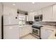 Kitchen with stainless steel appliances, white cabinets, and a tiled backsplash at 2890 W Long Cir # A, Littleton, CO 80120