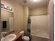 Bathroom with a shower/tub combo with patterned curtain and a single sink vanity at 7140 Simms St # 202, Arvada, CO 80004