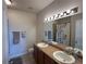Bathroom with double sinks, a shower with floral curtains, and tile floors at 7140 Simms St # 202, Arvada, CO 80004