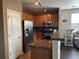 Kitchen with granite counters, stainless steel appliances, wood cabinets, and hardwood floors at 7140 Simms St # 202, Arvada, CO 80004
