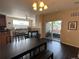 Open floor plan with dining area, kitchen, living room with fireplace, and sliding door to a balcony at 7140 Simms St # 202, Arvada, CO 80004