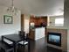 Open floor plan with a dining area, fireplace, and kitchen with hardwood floors at 7140 Simms St # 202, Arvada, CO 80004