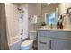Clean bathroom featuring white tile, modern fixtures, and a well-lit vanity area at 6682 Osage St, Denver, CO 80221