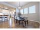 Elegant dining room featuring modern lighting, hardwood floors, and seamless flow to the kitchen at 6682 Osage St, Denver, CO 80221