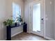 Bright foyer with a frosted glass door, modern console table, and lovely natural light at 6682 Osage St, Denver, CO 80221