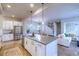 Spacious kitchen with stainless appliances, center island, and open layout to the living area and dining area at 6682 Osage St, Denver, CO 80221