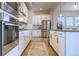 Well-appointed kitchen with stainless steel appliances, stone countertops, and ample cabinet space at 6682 Osage St, Denver, CO 80221