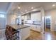 Bright kitchen showcasing a spacious island with seating, stainless steel appliances, and white cabinetry at 6682 Osage St, Denver, CO 80221