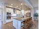 Modern kitchen featuring a large center island, stainless steel appliances, and pendant lighting at 6682 Osage St, Denver, CO 80221