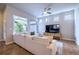 Bright living room with large windows, ceiling fan, and a comfortable white sectional sofa at 6682 Osage St, Denver, CO 80221
