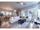 Open-concept living room with dining area, featuring large windows and stylish decor at 6682 Osage St, Denver, CO 80221