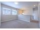 Cozy loft space featuring neutral carpet, bright windows, and ample natural light at 6682 Osage St, Denver, CO 80221