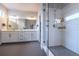 Modern main bathroom with double vanity, subway tile shower, and glass door at 6682 Osage St, Denver, CO 80221