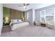 Stylish main bedroom with unique wood accent wall, carpet, and bright natural light at 6682 Osage St, Denver, CO 80221