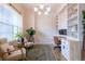 Comfortable home office featuring built-in shelving, neutral decor, and ample natural light at 6682 Osage St, Denver, CO 80221