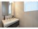 Stylish powder room with modern vanity, vessel sink, and neutral finishes at 6682 Osage St, Denver, CO 80221