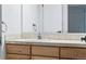 Bathroom vanity with wooden cabinets and a large mirror with vanity lighting at 969 S Pearl St # 103, Denver, CO 80209