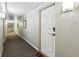 A hallway with gray walls and a front door with a digital lock and house number at 969 S Pearl St # 103, Denver, CO 80209