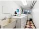 Laundry room featuring rows of washing machines and large sink for shared laundry at 969 S Pearl St # 103, Denver, CO 80209