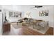 Living room with hardwood floors, natural light, comfortable seating, and dining area at 969 S Pearl St # 103, Denver, CO 80209