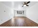 Bright, open living room with hardwood floors, a ceiling fan, and a large window at 969 S Pearl St # 103, Denver, CO 80209