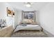 Stylishly decorated bedroom with neutral colors and a view through the window at 969 S Pearl St # 103, Denver, CO 80209