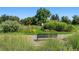 Serene park view with a bench, surrounded by manicured gardens and natural greenery at 969 S Pearl St # 103, Denver, CO 80209