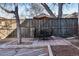 Outdoor patio with shade umbrella and metal table and chairs on a brick paver patio at 969 S Pearl St # 103, Denver, CO 80209