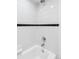 Shower and bathtub with white tile and black accent stripe at 969 S Pearl St # 103, Denver, CO 80209