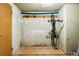 Storage area for bikes and other items with a small door and wall mounted hooks at 969 S Pearl St # 103, Denver, CO 80209