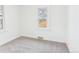 Minimalist bedroom with neutral carpeting, a large window, and clean, bright walls at 3150 S Pennsylvania Street, Englewood, CO 80113