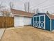 View of shed, with white cross, next to white garage at 3150 S Pennsylvania Street, Englewood, CO 80113