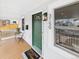 Inviting porch with a green front door, stylish light fixture, and a welcoming doormat at 3150 S Pennsylvania Street, Englewood, CO 80113