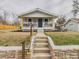 Charming home featuring a quaint porch, stone accents, and a well-maintained front yard at 3150 S Pennsylvania Street, Englewood, CO 80113
