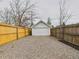 Garage with gravel driveway and wooden fences on either side at 3150 S Pennsylvania Street, Englewood, CO 80113