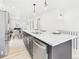 Open-concept kitchen featuring a large island with seating and stainless steel appliances at 3150 S Pennsylvania Street, Englewood, CO 80113
