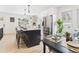 Modern kitchen with stainless steel appliances, a center island with seating, and light countertops at 3150 S Pennsylvania Street, Englewood, CO 80113
