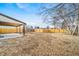 Large backyard with a wooden fence and covered patio at 1017 Florence St, Aurora, CO 80010