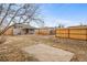 Large backyard with a concrete slab and wooden fence at 1017 Florence St, Aurora, CO 80010