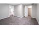 Finished basement room with carpet and access to other rooms at 1017 Florence St, Aurora, CO 80010