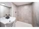 Basement bathroom with tile shower and vanity at 1017 Florence St, Aurora, CO 80010