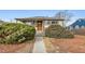 Cute bungalow with a landscaped yard and a welcoming front porch at 1017 Florence St, Aurora, CO 80010