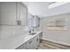 Modern kitchen with gray cabinets, quartz countertops and black hardware at 1017 Florence St, Aurora, CO 80010