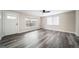 Bright living room featuring gray vinyl plank flooring and a ceiling fan at 1017 Florence St, Aurora, CO 80010