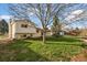 An expansive backyard that includes a large lawn with mature trees and landscaping at 814 Glenwood Dr, Lafayette, CO 80026