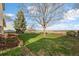 Expansive backyard featuring green lawn, mature tree, and scenic view at 814 Glenwood Dr, Lafayette, CO 80026