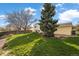 A large backyard with a mature tree and partial fence at 814 Glenwood Dr, Lafayette, CO 80026