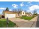 Suburban homes along a street show tidy lawns, driveways, and garages on a sunny day with blue skies at 814 Glenwood Dr, Lafayette, CO 80026